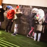Cocoon Childcare - Talllaght - Children using chalk on black wall
